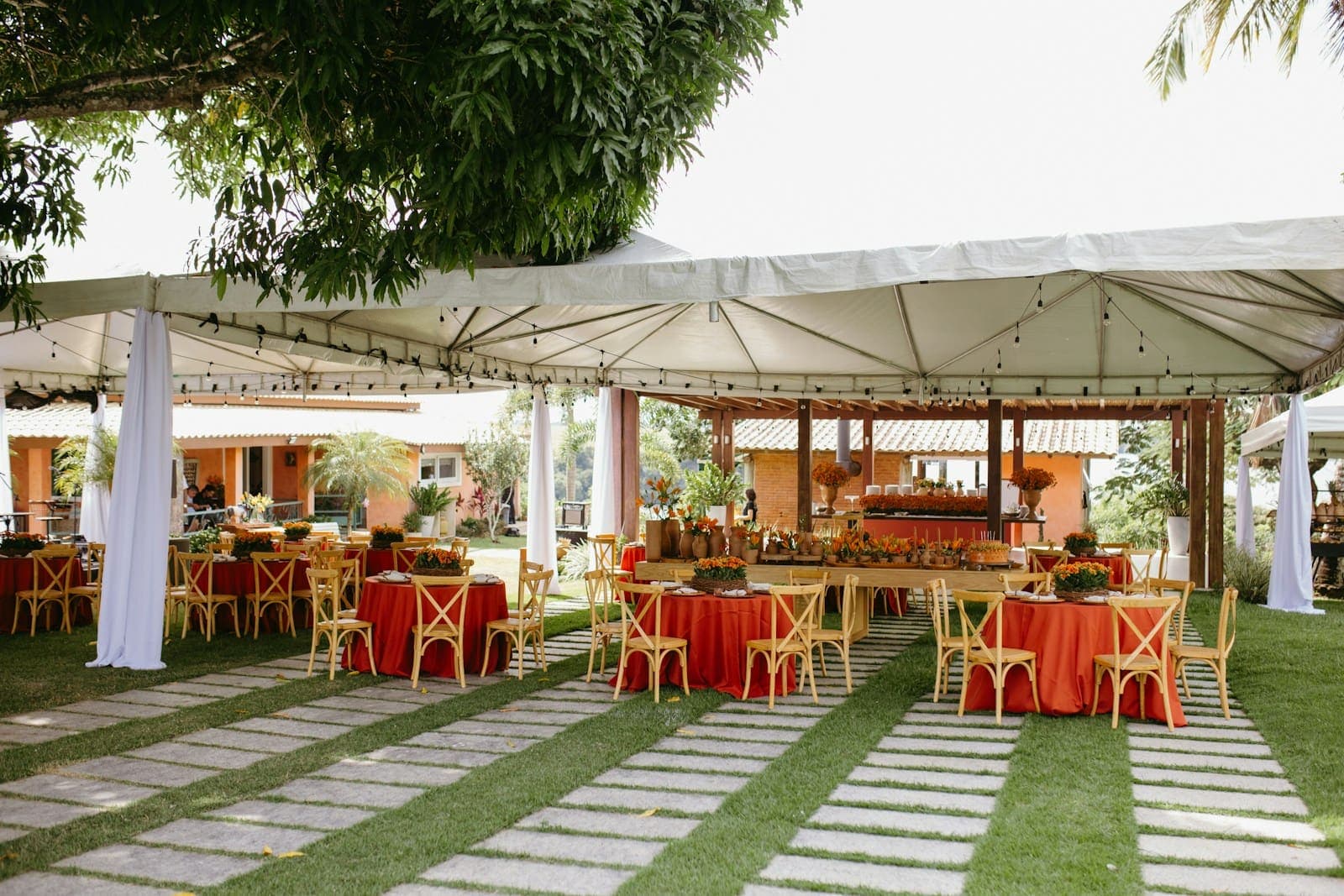 An outdoor event set up with tables and chairs on grass